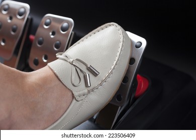 Woman's Foot Pressing The Gas Pedal.