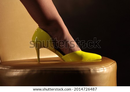 Woman's foot with yellow high heels