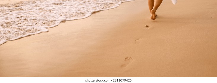 woman's footsteps on the beach  - Shutterstock ID 2311079425