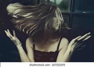 Woman's Hair Are Being Blown Away In A Swirling Wind