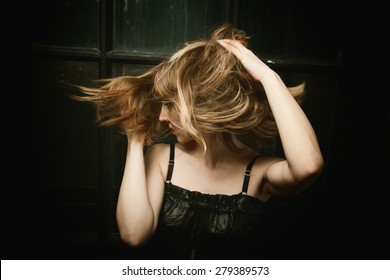 Woman's Hair Are Being Blown Away In A Swirling Wind