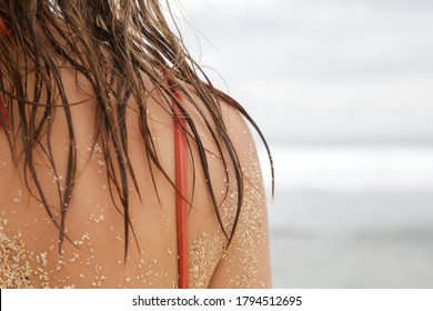 Woman's Hair On The Beach, Sand On The Skin And Wet Hair Close Up Image. Hair Damage Due To Salty Ocean Water And Sun, Summer Time Hair Care Concept. 