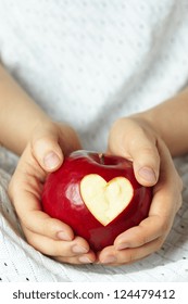 Woman's Hand With Apple, Which Cut A Heart