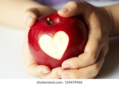 Woman's Hand With Apple, Which Cut A Heart