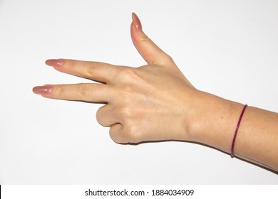 Woman's Hand With Bent Two Fingers And A Red Thread On The Wrist. Female Hand Have A Long Nails And Show Three Fingers