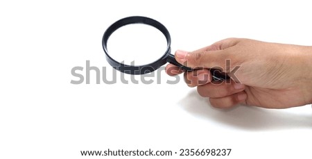Woman's hand with brown skin holds a magnifying glass or loupe. isolated on white background. clean white empty space. concept of search, mystery, discovery.
