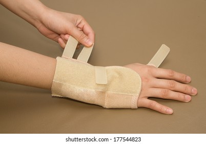 Woman's Hand With Carpal Tunnel Syndrome Remove The Wrist Brace