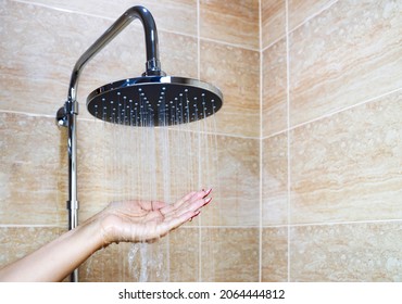 Woman's Hand Check Water Temperature In The Shower 