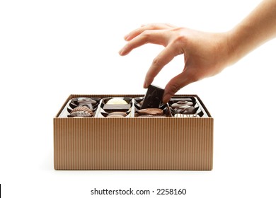 A Woman's Hand Choosing A Chocolate From A Box