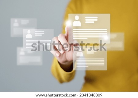 Woman`s hand choosing virtual cv cards with candidates information. Human resources concept.Illustrative material for articles and web.