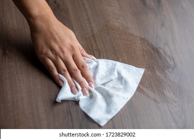 Woman's Hand Cleaning Home Office Table Surface With Wet Wipes