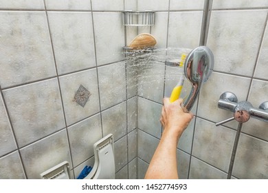 A Woman's Hand Is Cleaning A Shower Cubicle