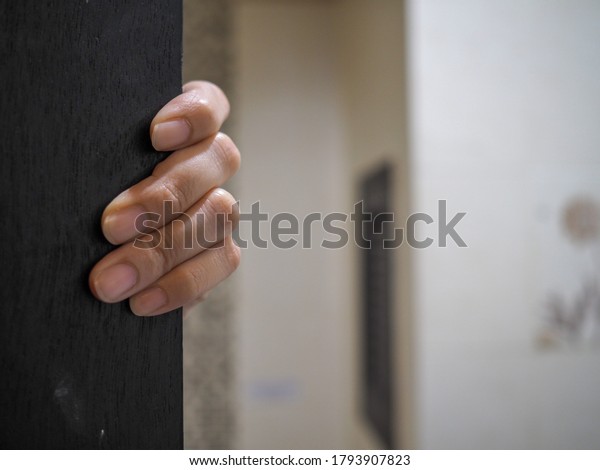 A woman\'s hand clung to the edge of the\
door and was about to open to a tainted\
form.