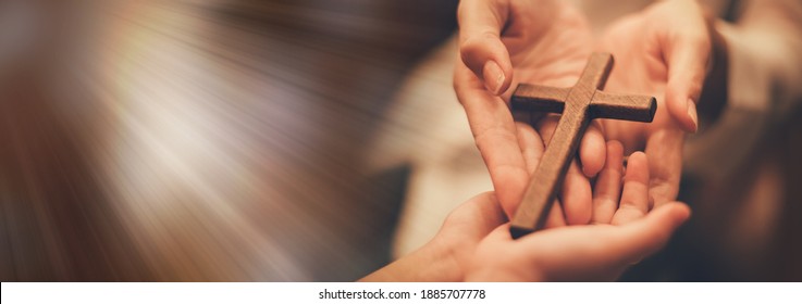 Woman's hand with cross .Concept of hope, faith, christianity, religion, church online. - Shutterstock ID 1885707778