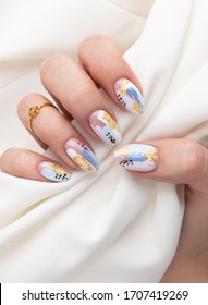 Woman's Hand With Fashionable Nails Holding Fabric. Spring Summer Nail Design. Manicure, Pedicure Beauty Salon Concept.