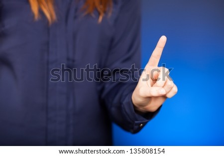 Woman's hand with finger on blue background