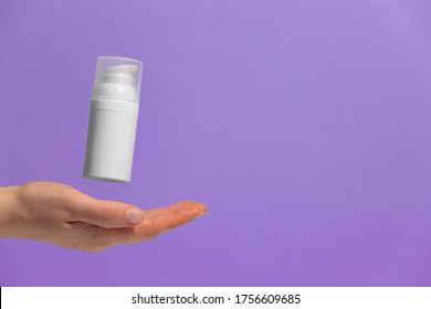 Woman's Hand With Floating Cosmetic Product Without Brand, Free Space For Text. Making Advertisement.