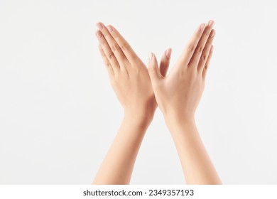 A woman's hand gesture separated against a white background. High-definition studio shooting