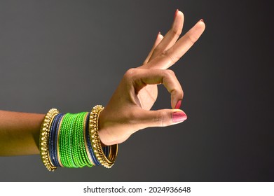 The woman's hand and the green bangle look beautiful.