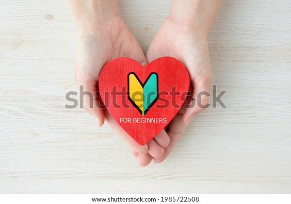 Woman\'s hand and Heart object with Japanese\
beginner\'s sign