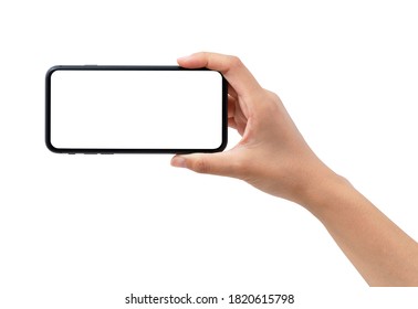A woman's hand holding a black smartphone. - Shutterstock ID 1820615798