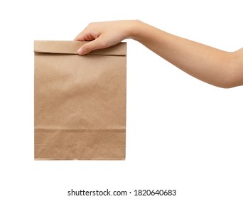 A Woman's Hand Holding A Brown Paper Bag
