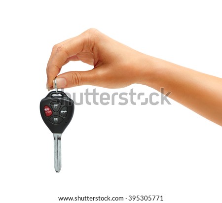 Woman's hand holding car keys isolated on white background. Close up