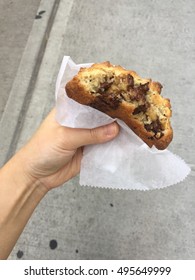 Woman's Hand Holding Chocolate Chip Cookie