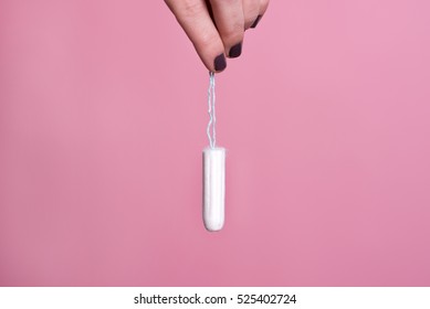 Woman's Hand Holding A Clean Cotton Tampon