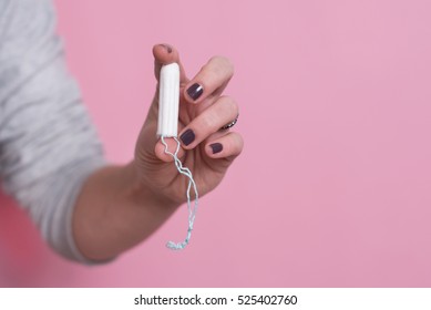 Woman's Hand Holding A Clean Cotton Tampon