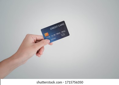 Woman's Hand Holding The Credit Card For Shopping Online.