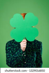 Woman's Hand Holding A Four Leaf Clover