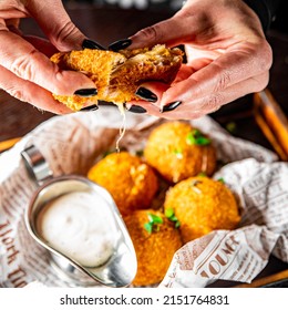 Woman's Hand Holding Fried Mozzarella Cheese Ball