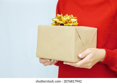 Woman's Hand Holding A Gift Box With A Bow. Delivery Express, Christmas Sale. Online Shopping. New Year Gifts. Online Delivery. Christmas Discounts.