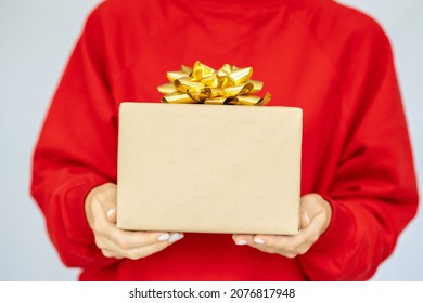 Woman's Hand Holding A Gift Box With A Bow. Delivery Express, Christmas Sale. Online Shopping. New Year Gifts. Online Delivery. Christmas Discounts.