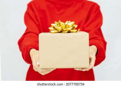 Woman's Hand Holding A Gift Box With A Bow. Delivery Express, Christmas Sale. Online Shopping. New Year Gifts. Online Delivery. Christmas Discounts.