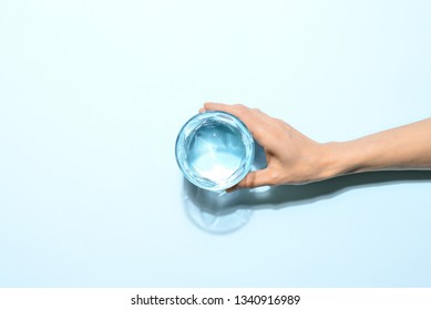 Woman's Hand Holding A Glass Of Water, Minimalist Concept, View From Above, Blank Space For A Text