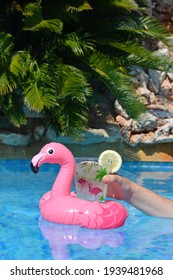 Woman's Hand Holding An Ice Cold Drink In Swimming Pool