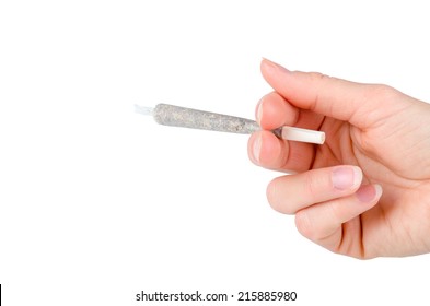 Womans hand holding a marijuana joint isolated on white background
