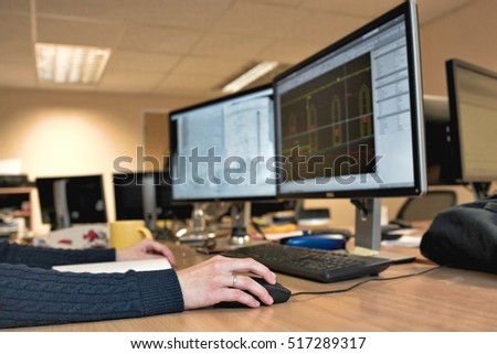 Woman's hand holding a mouse for office design work. Female architect designing building