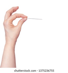 Woman's hand holding a needle on white background.