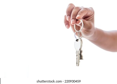 Woman's Hand Holding The New House Keys On A White Background 