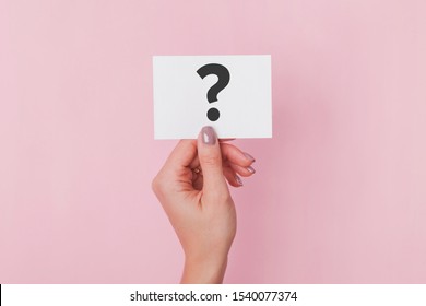 Woman's Hand Holding Paper Card With Question Sign On It