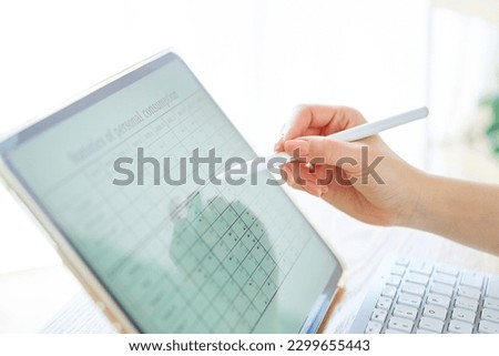 Woman's hand holding a stylus pen