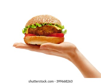 Woman's hand holding tasty hamburger isolated on a white background. Close up