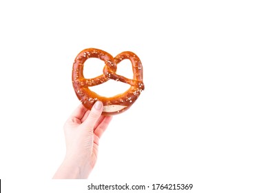 Woman's Hand Holding Traditional Bavarian Salty Pretzel