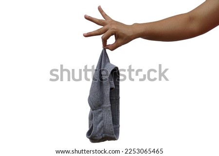 Woman's hand holding used men's underwear on white background The picking sensation looks disgusting when handling used clothing.