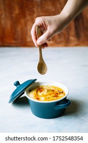 A Woman's Hand Holding A Wooden Spoon To Eat A Delicious Hummus With Olive Oil And Paprika. Food Concept