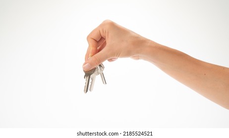 A Woman's Hand Holds A Bunch Of Keys On A White Background