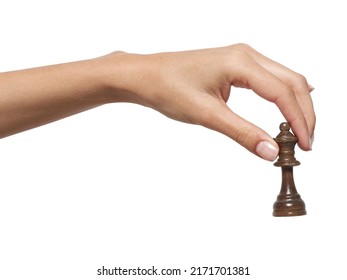 A woman's hand holds a chess piece on a white background, isolat - Shutterstock ID 2171701381